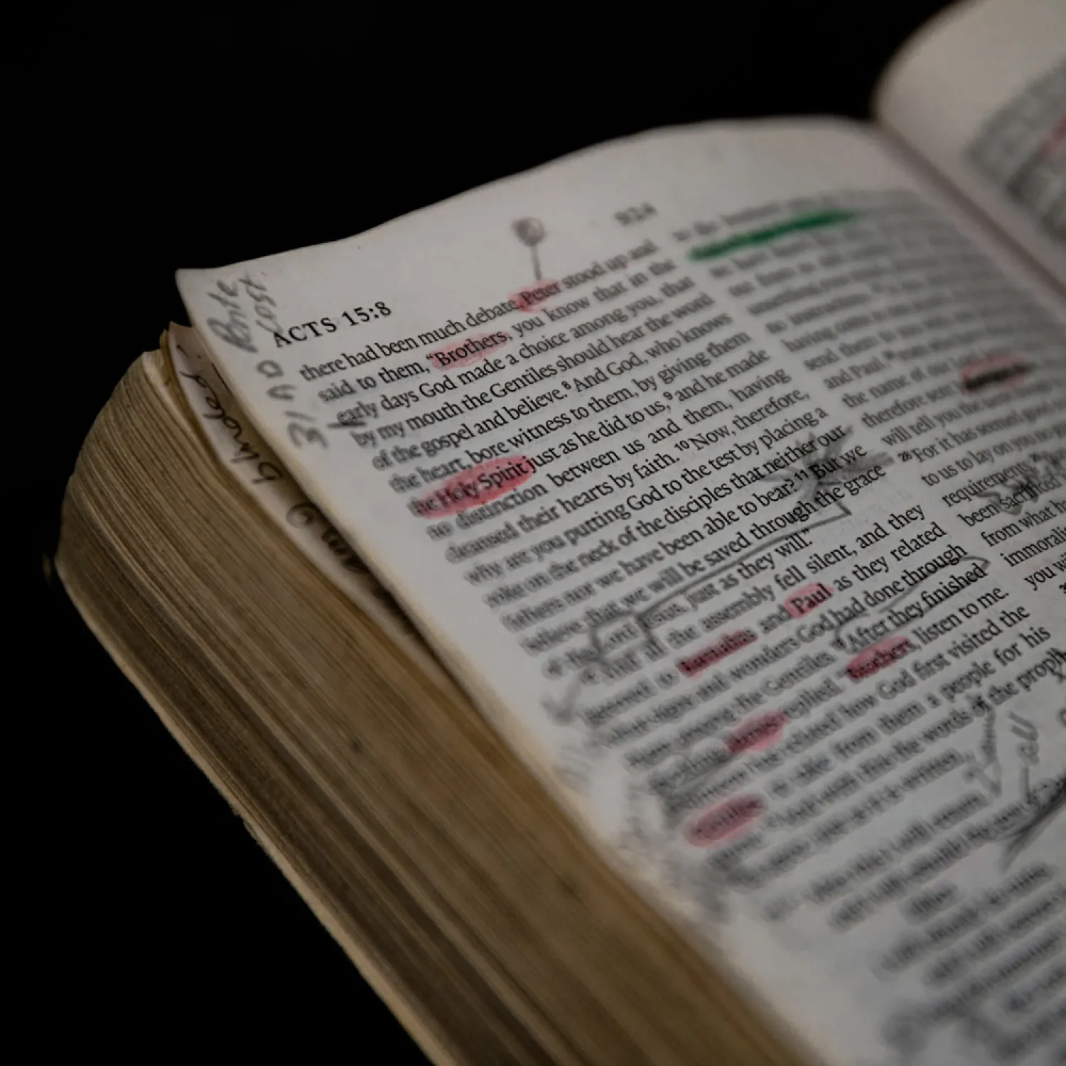 A close up image of a bible containing underlined and highlighted sections.