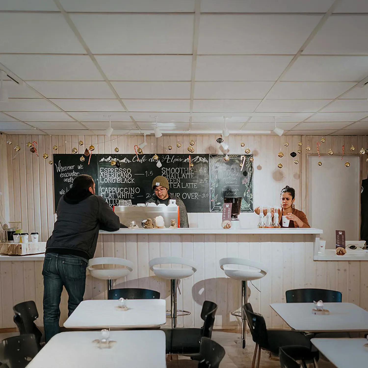 Campus coffee shop with students working and standing around.