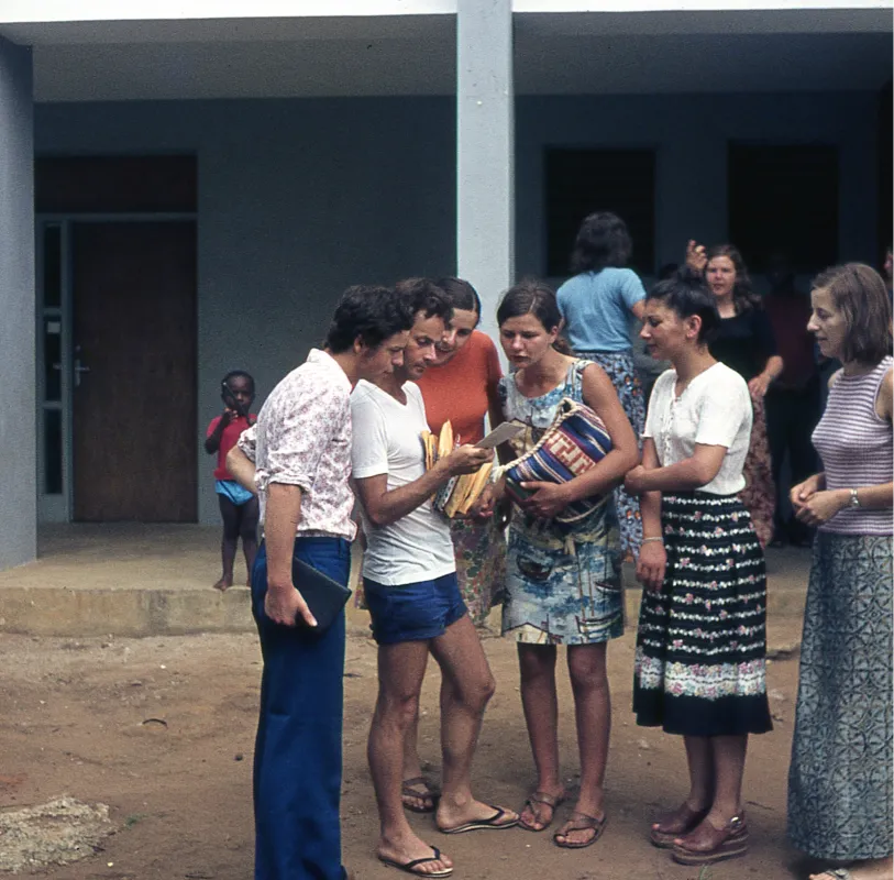 A group of YWAM students gathered around looking at a map.