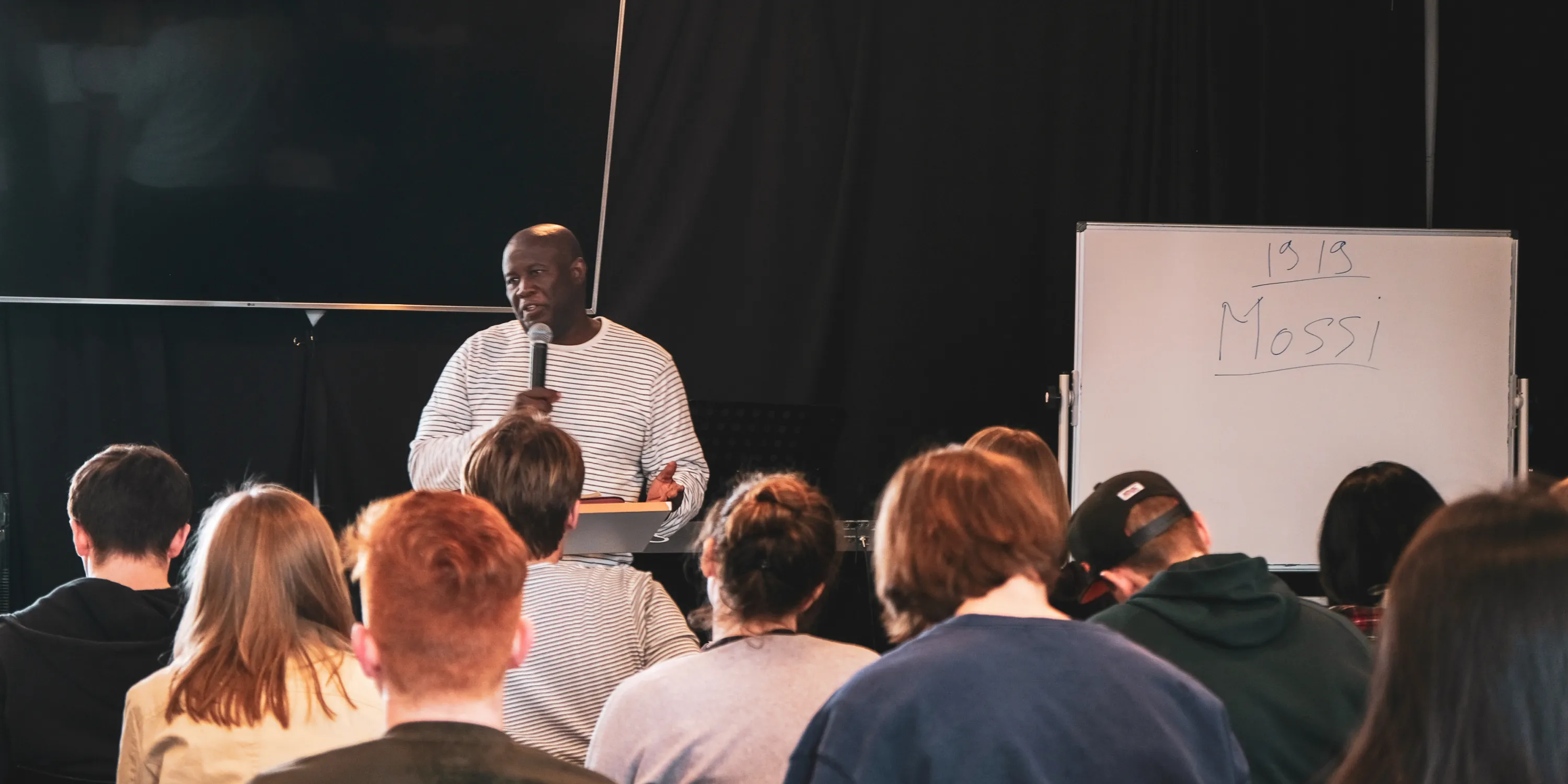 A lecturer speaking to students at YWAM Lausanne campus during a lecture.