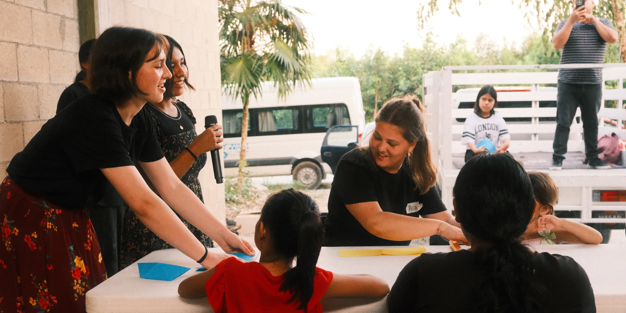 Students engaging with each other around a table on an Outreach trip.