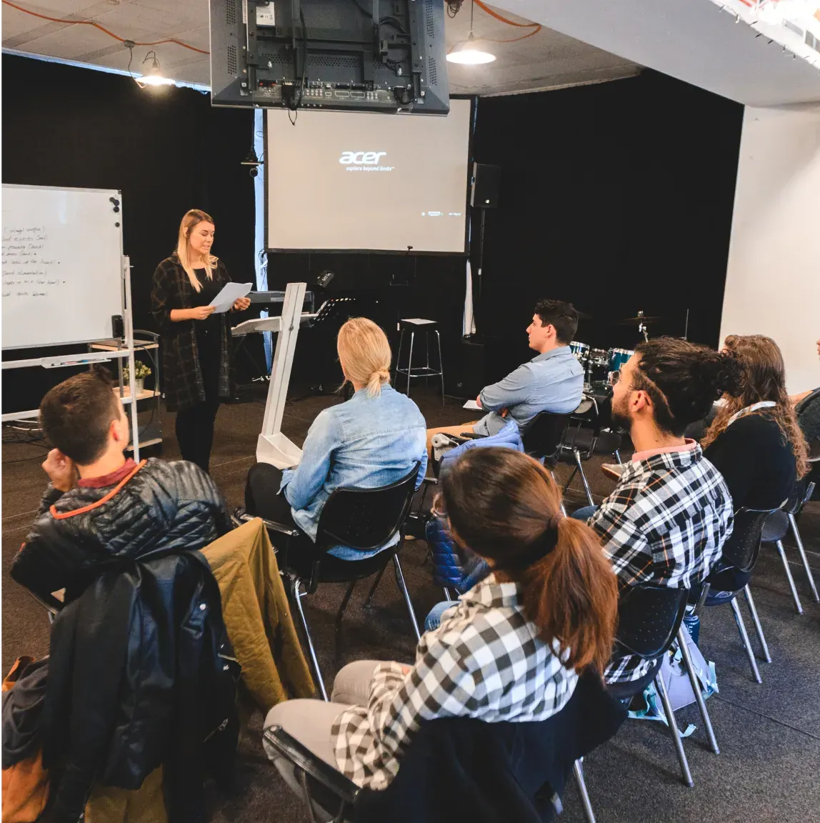An image of a group of students sitting in a lecture hall listening to a lecdturer.